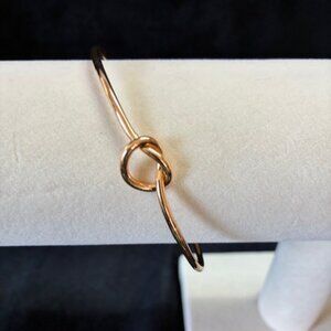 Gold tone love knot bracelet